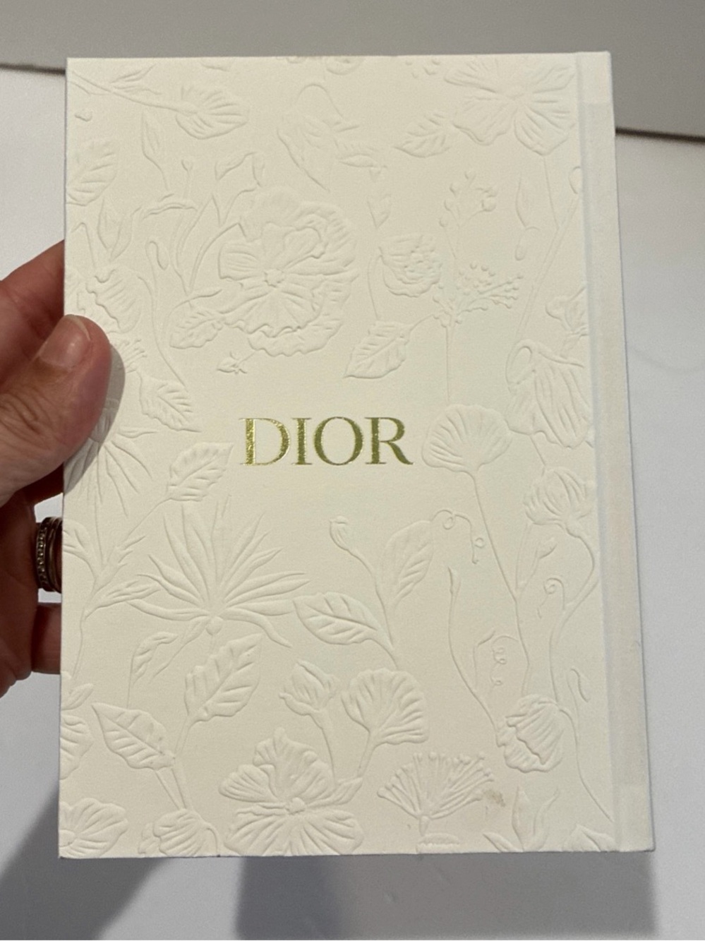 DIOR Cream Embossed Floral notebook with Gold Logo and ribbon